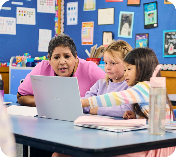 A teacher with two students on a laptop