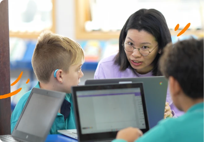 A lady is teaching two children