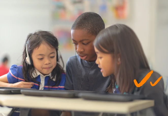 Three student are looking at a screen together