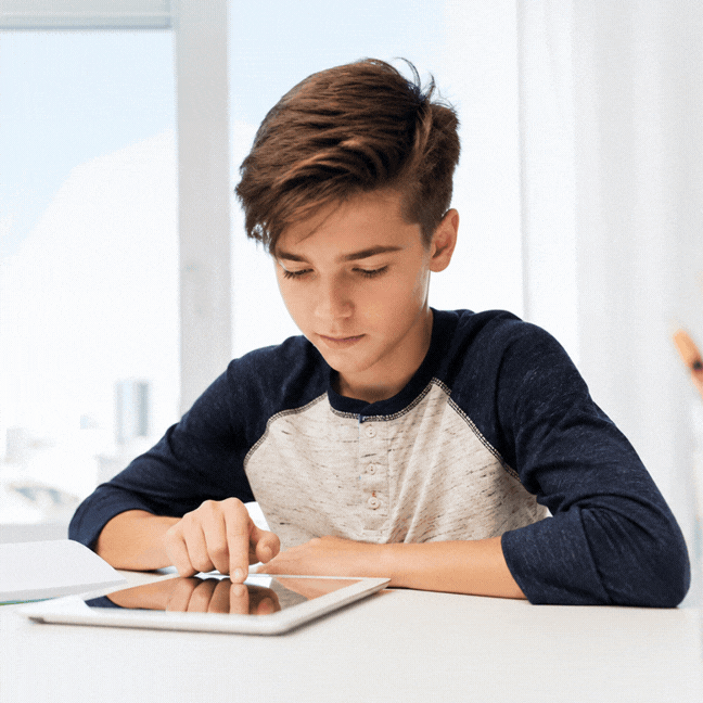 Animated clip of a student sitting at a table and tapping on a tablet screen in a bright room.