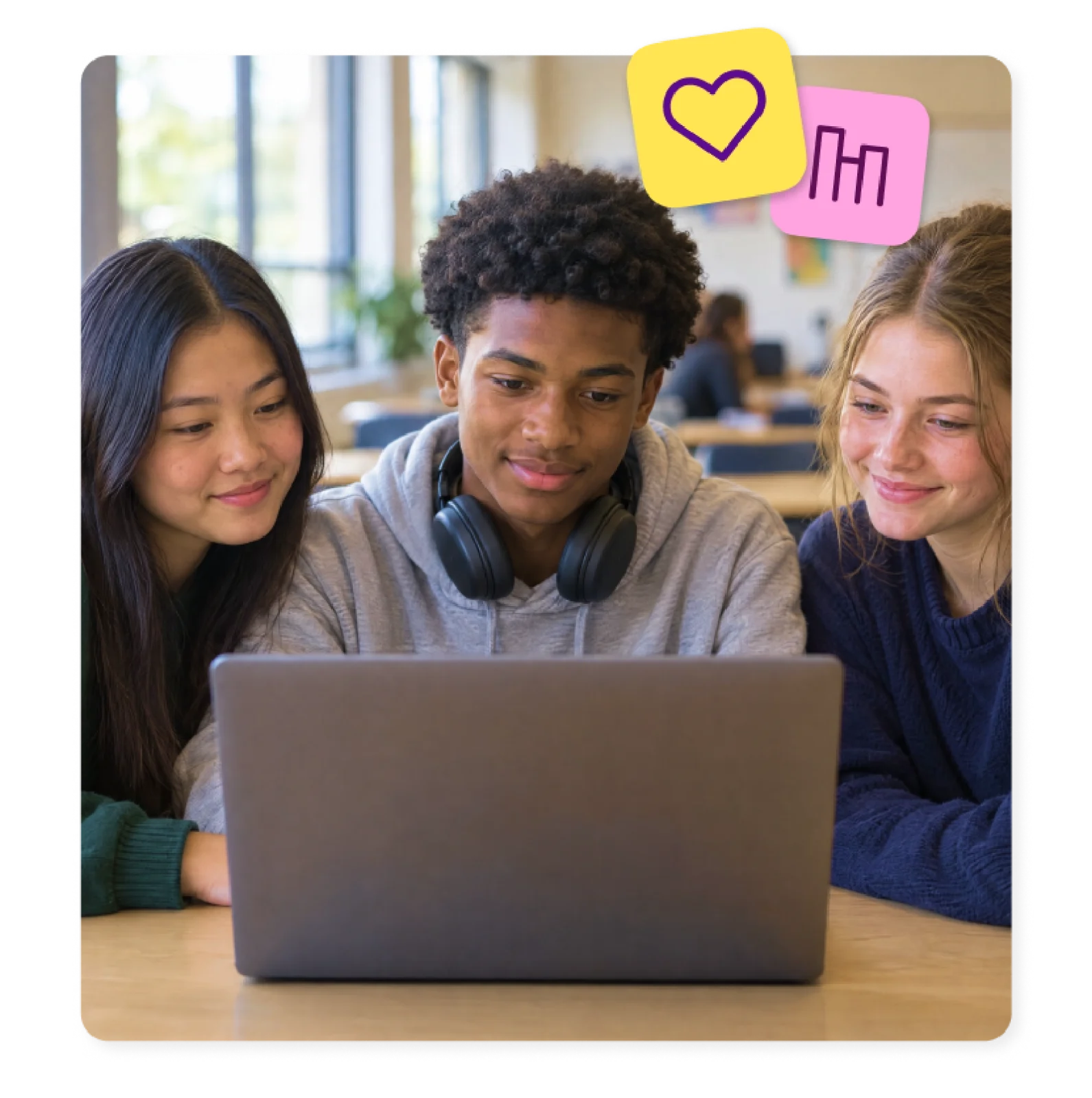 Three students share a laptop and work together through accessible learning.
