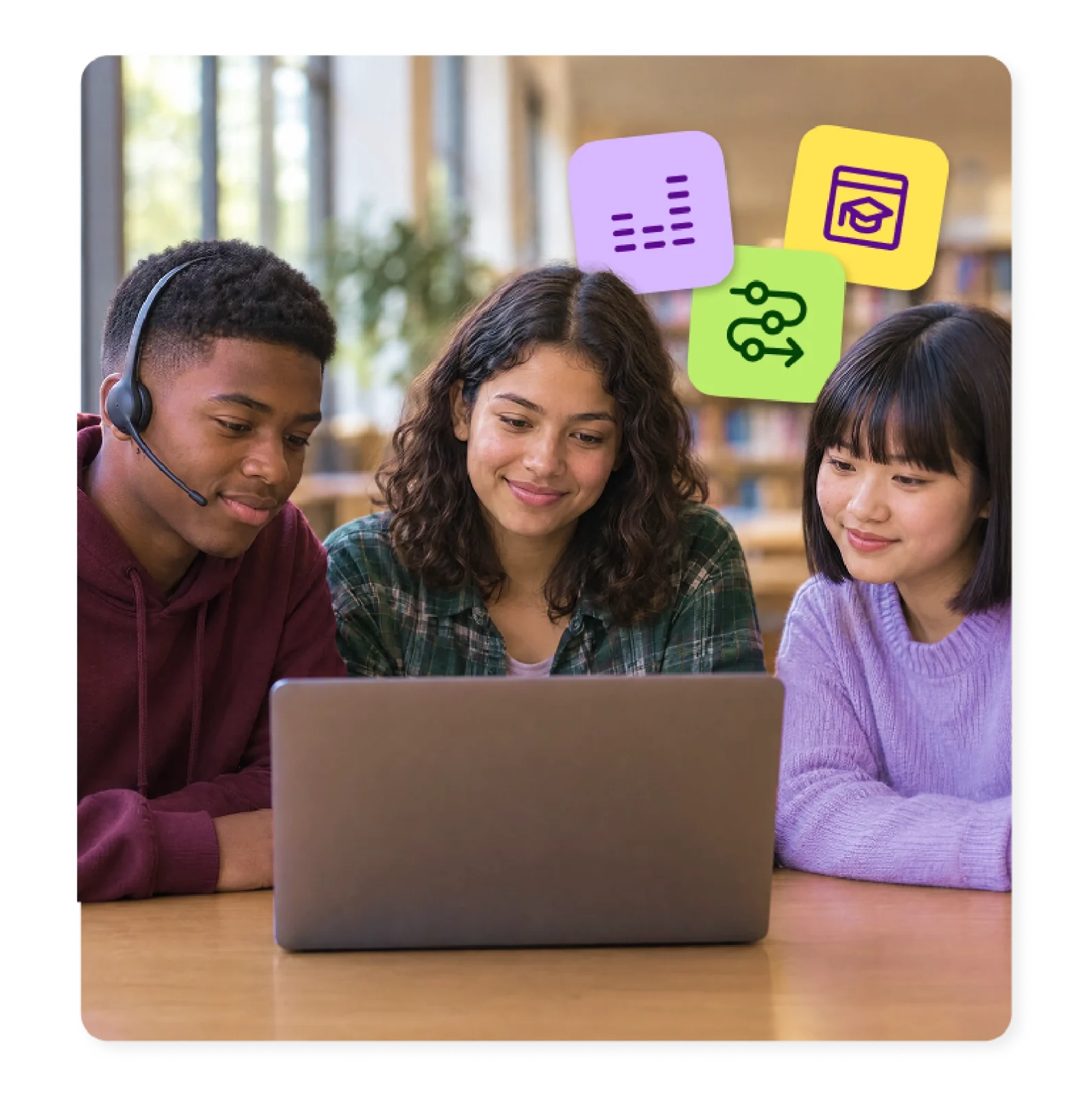 High school English language learners work together on a laptop.