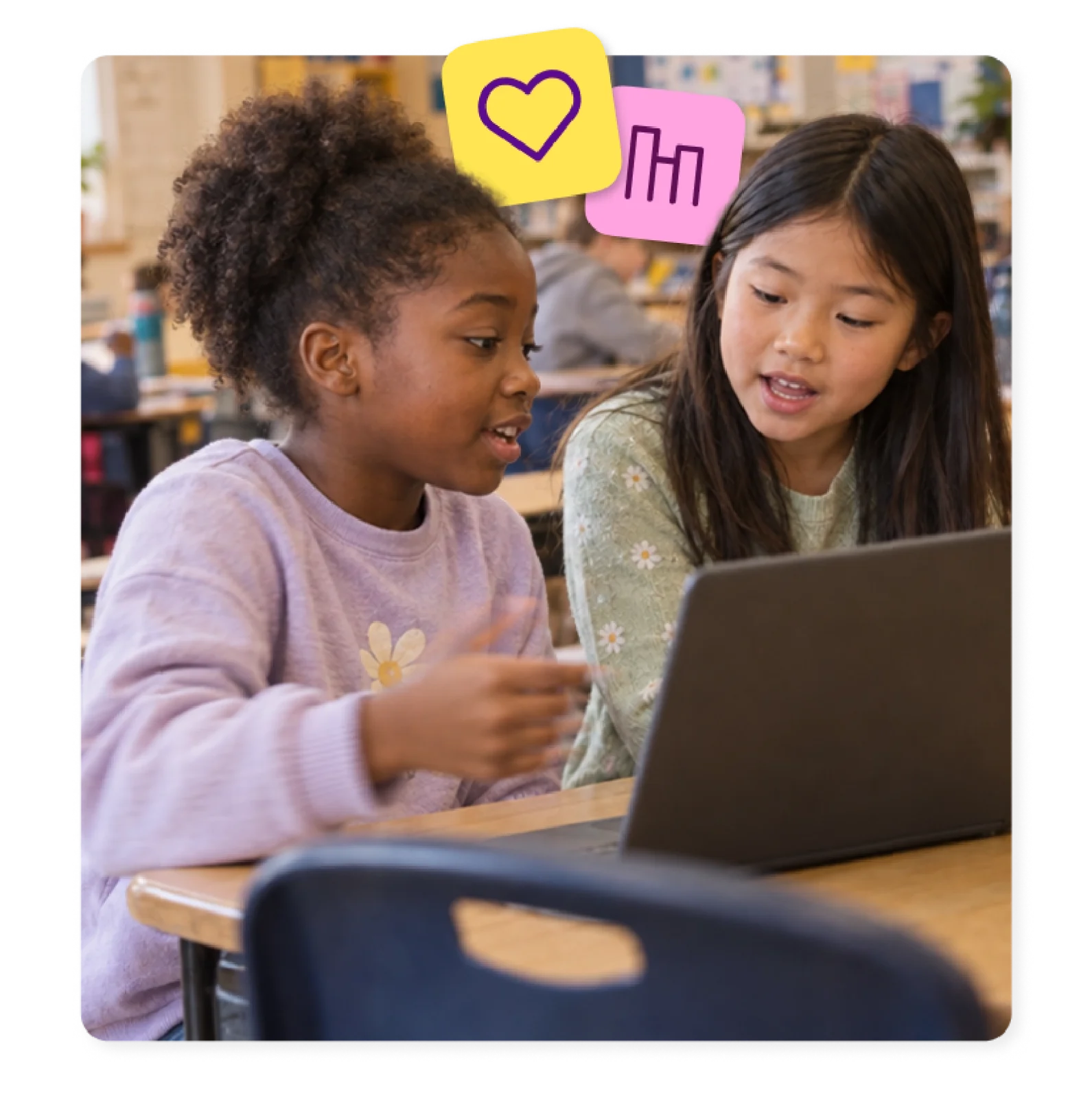Two students talk through their work on a laptop, using blended learning tools with purpose.