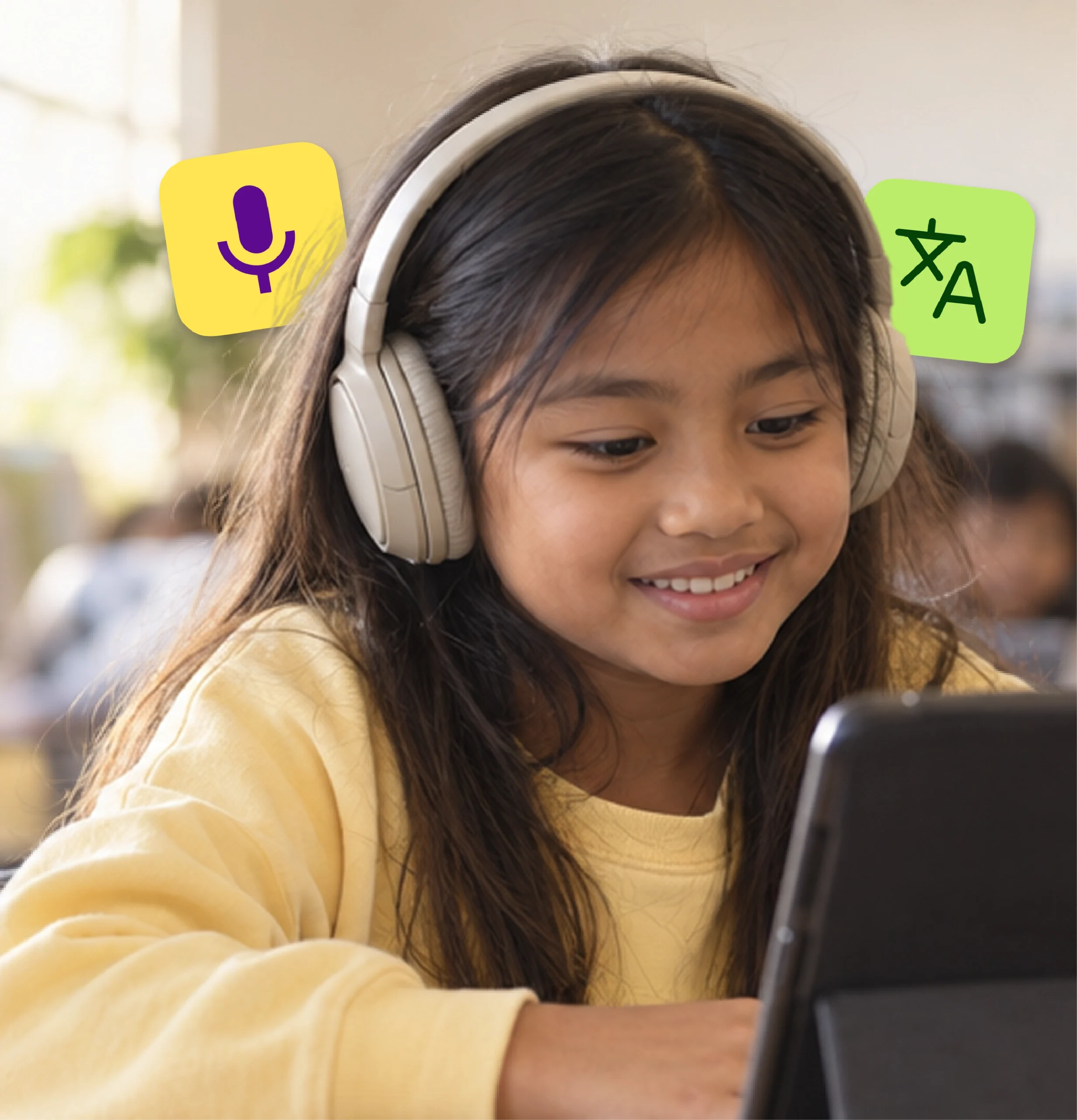 An elementary student in headphones smiles at her tablet during class.