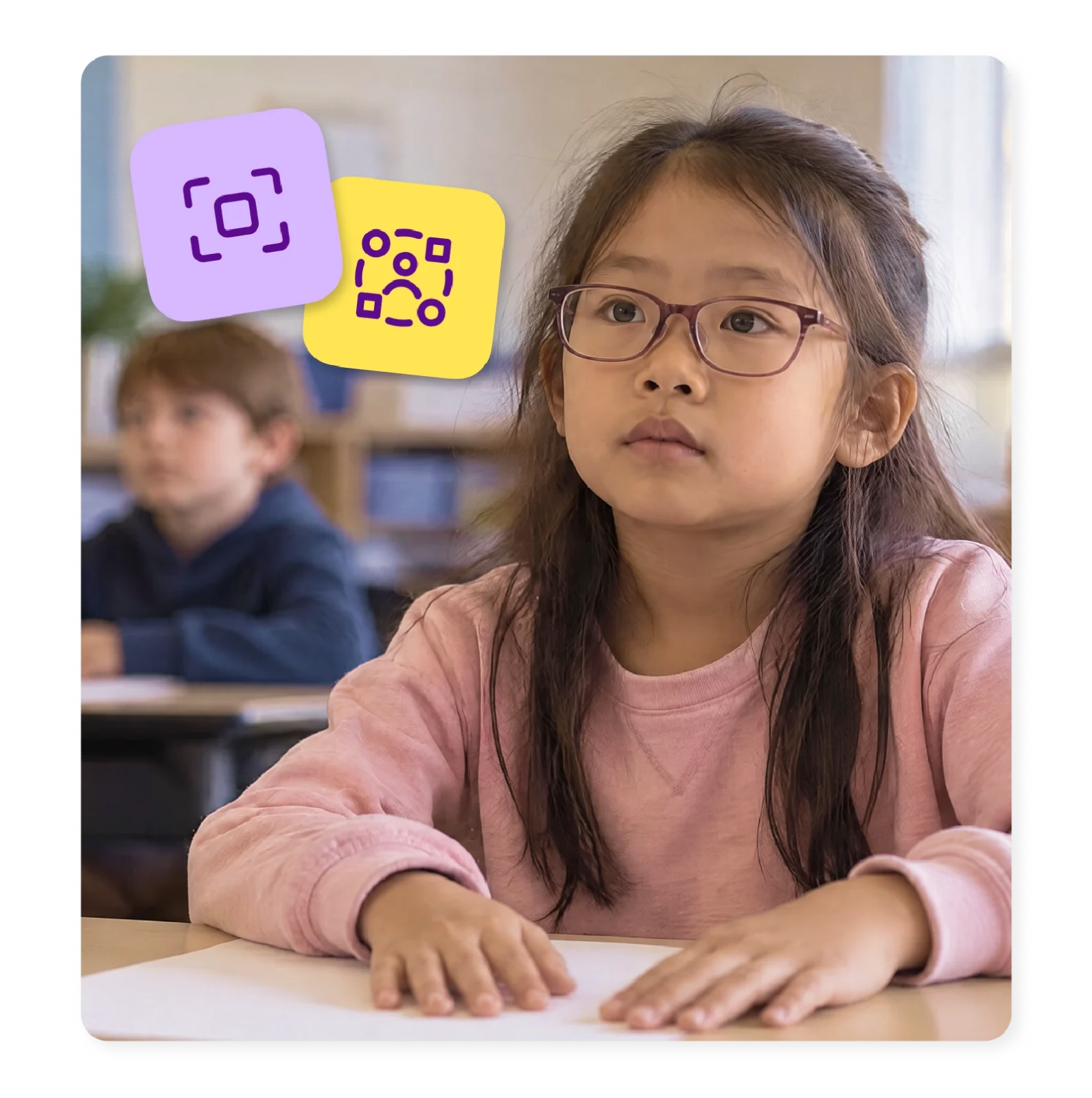 An elementary student waits at her desk beside a blank worksheet.