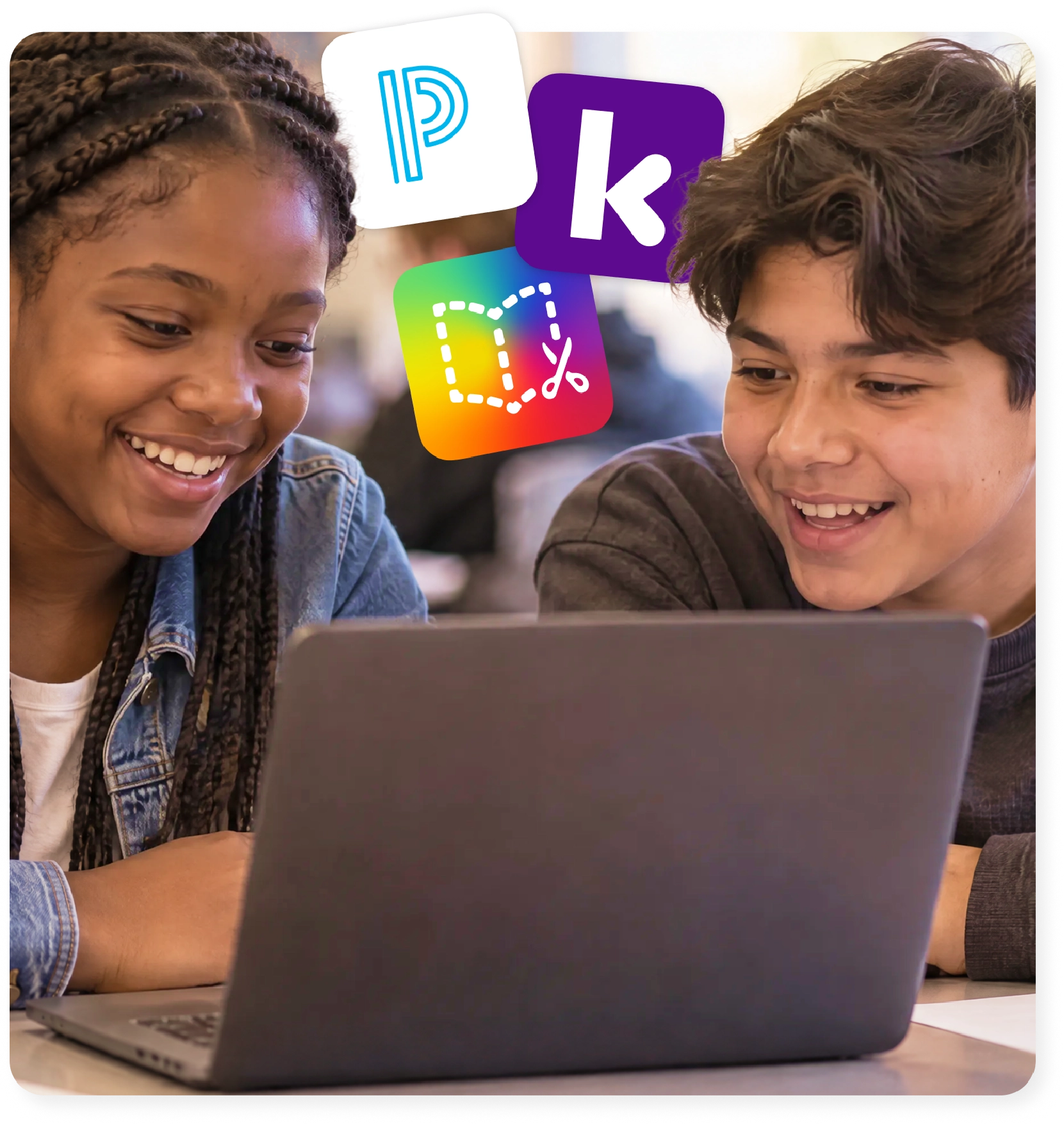 Two middle school students work together on a laptop using the Kami Schoology integration.